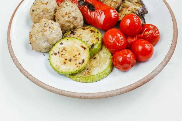 What Techniques Ensure a Crisp and Flavorful Gourmet Zucchini Fritter with Feta?